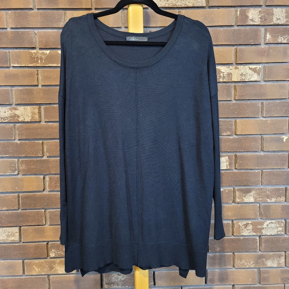 Black scoop neck stretch knit sweater with double hip vents center seam